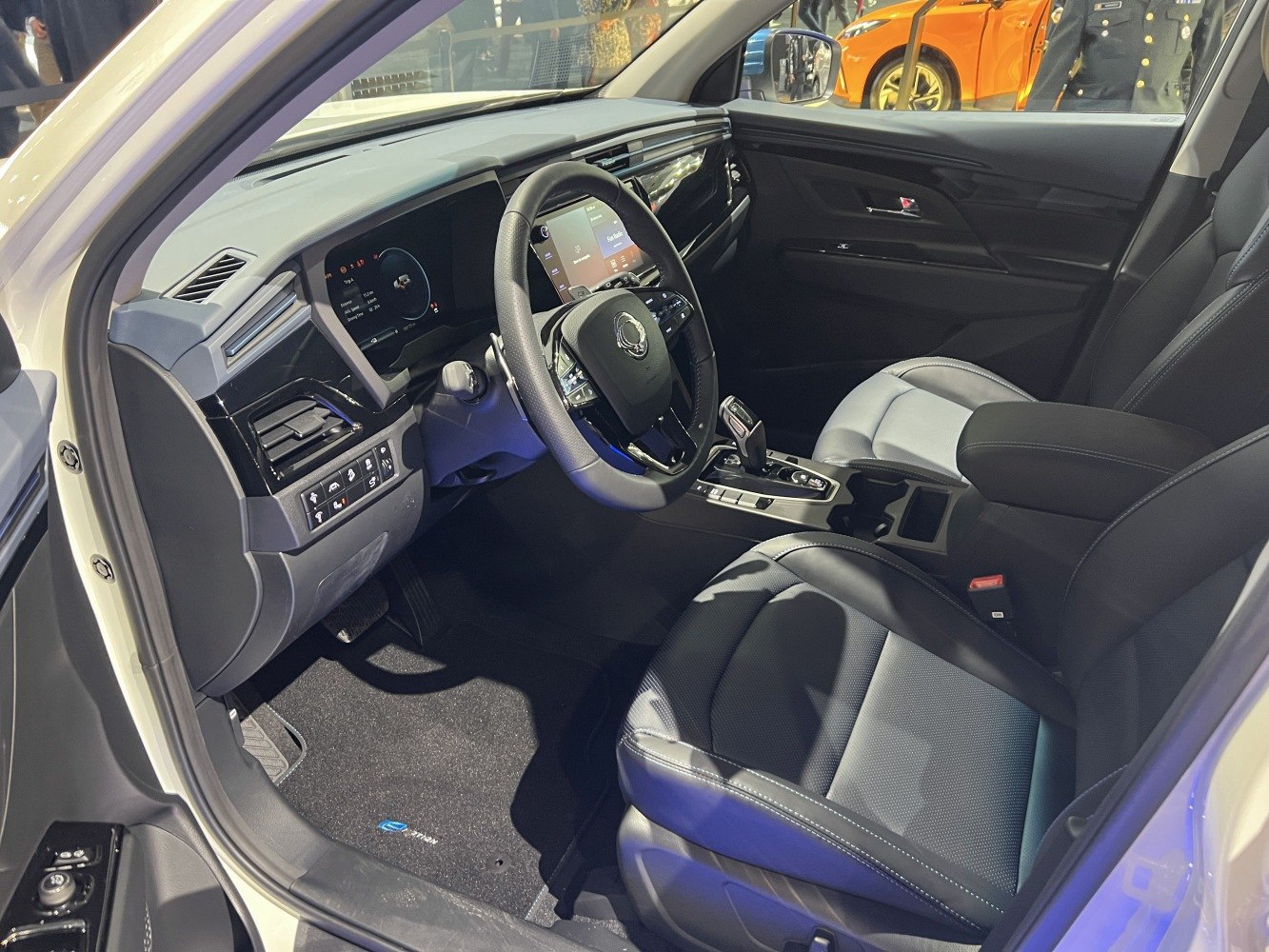 Modern dashboard and front seats interior with digital displays and automatic gear shift