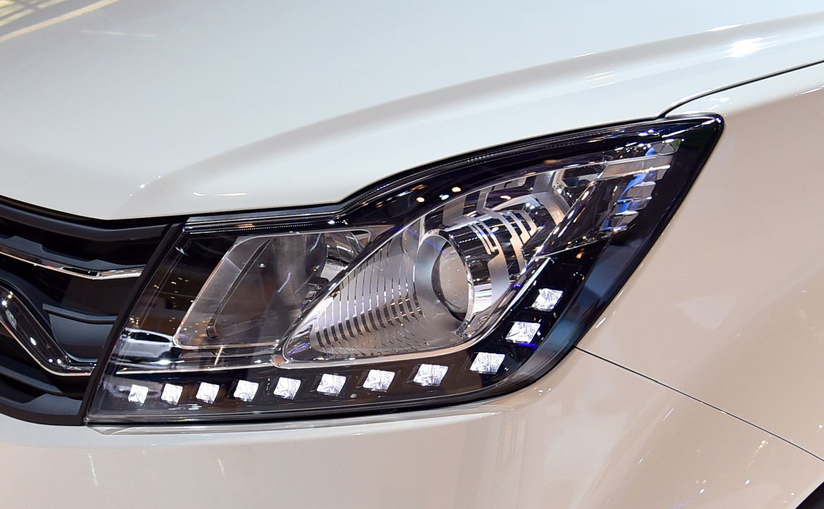 Close-up of headlight with LED DRLs and projector lens