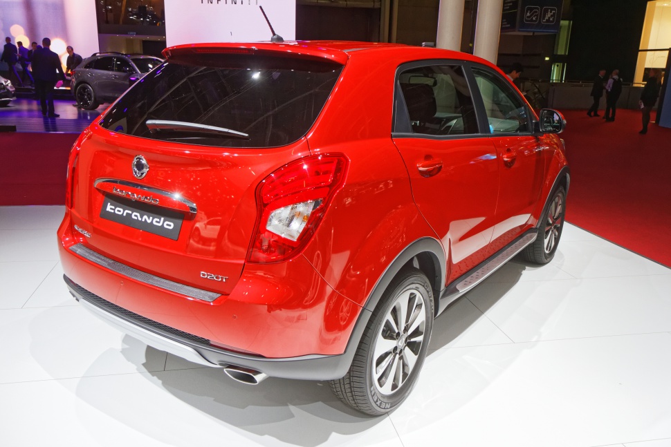 Rear and side profile of red SUV with distinctive taillights and alloy wheels