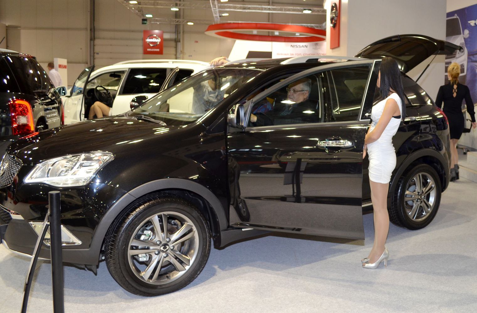 Side view of black SUV with open front door and alloy wheels