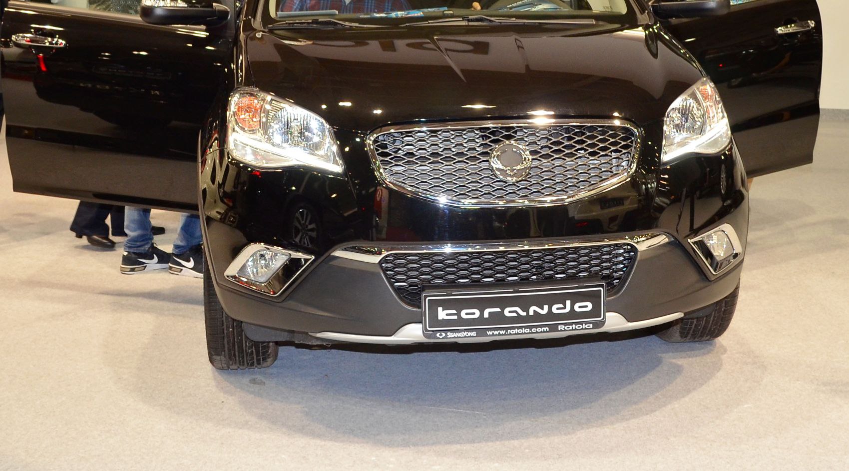 Close-up of SUV front grill, headlights, and open doors