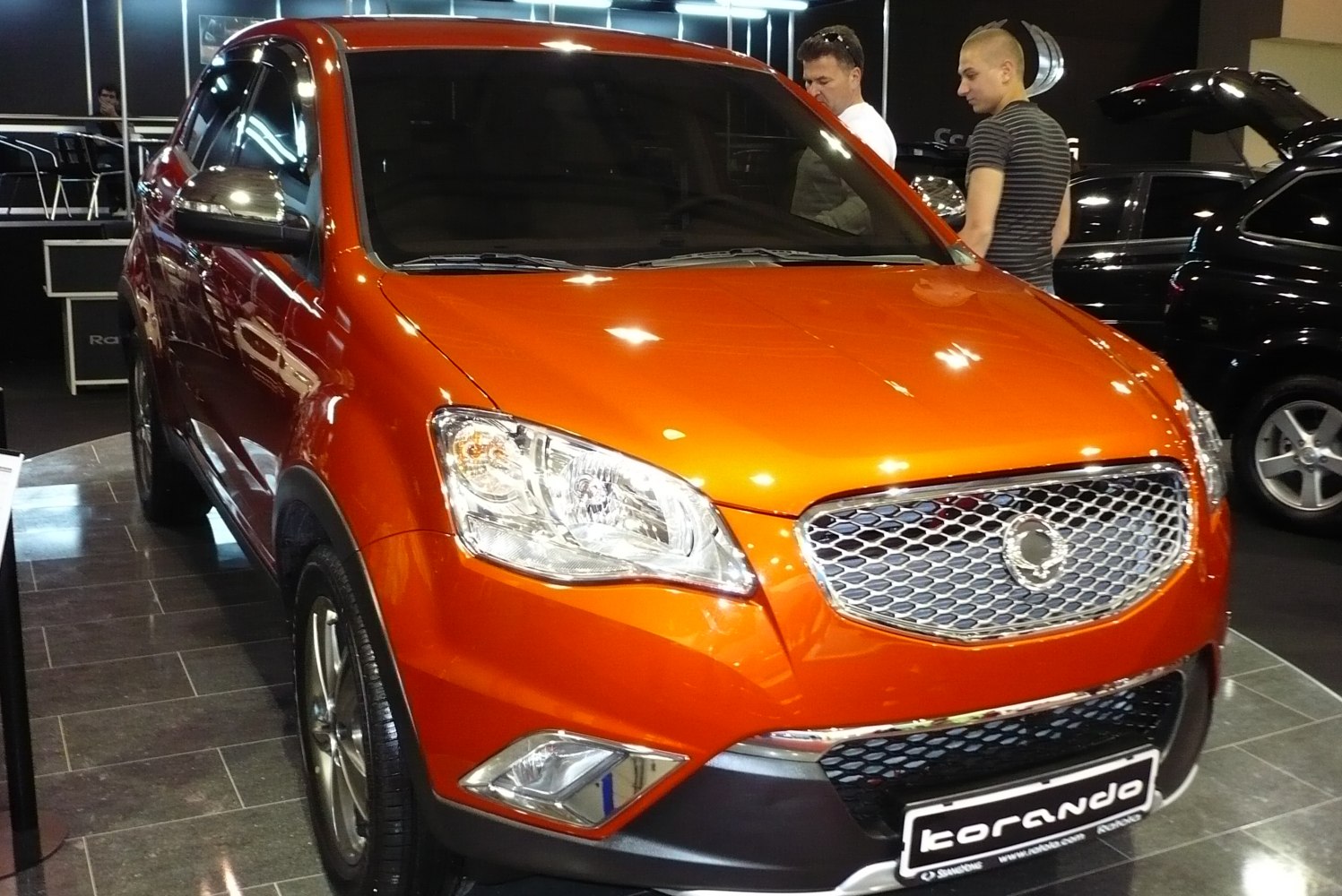 Orange SUV with mesh grille and prominent headlights