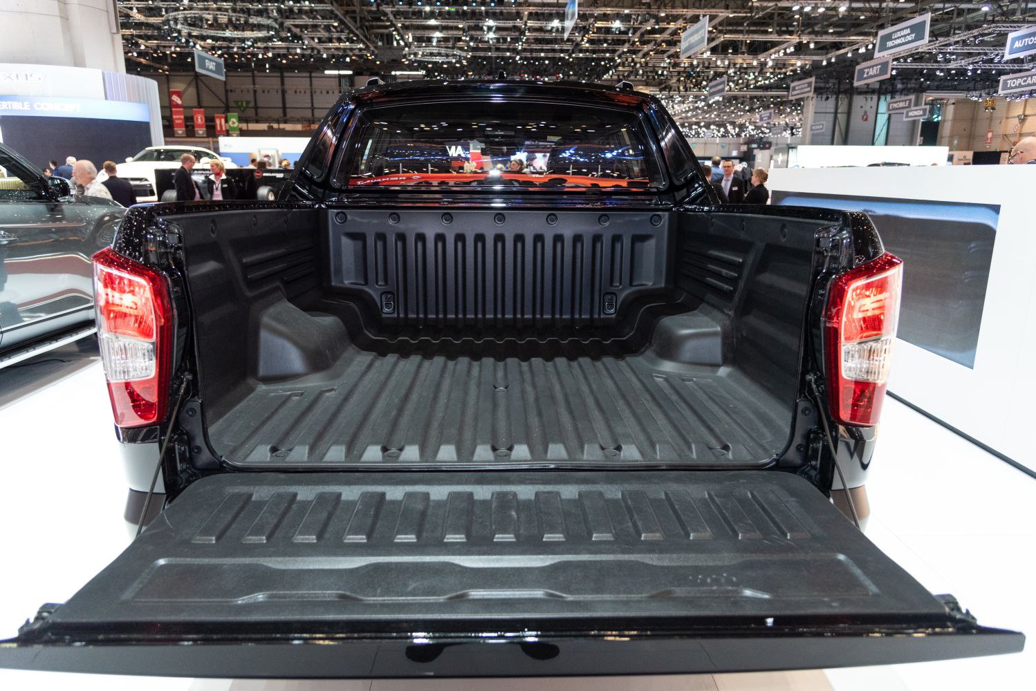 Open pickup truck bed with tailgate down and rugged liner.