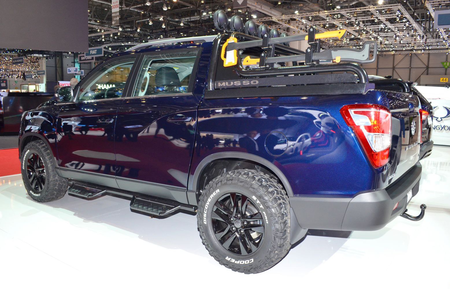Pickup truck rear side with off-road tires and roof rack
