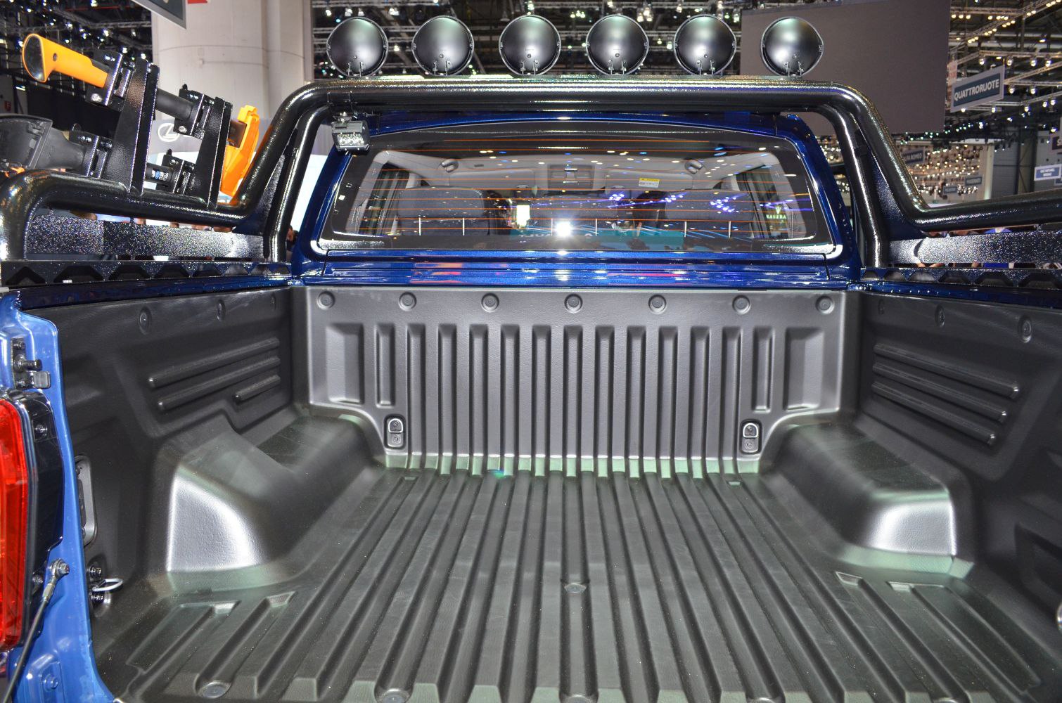 Durable truck bed liner and multiple off-road lights on rear bar