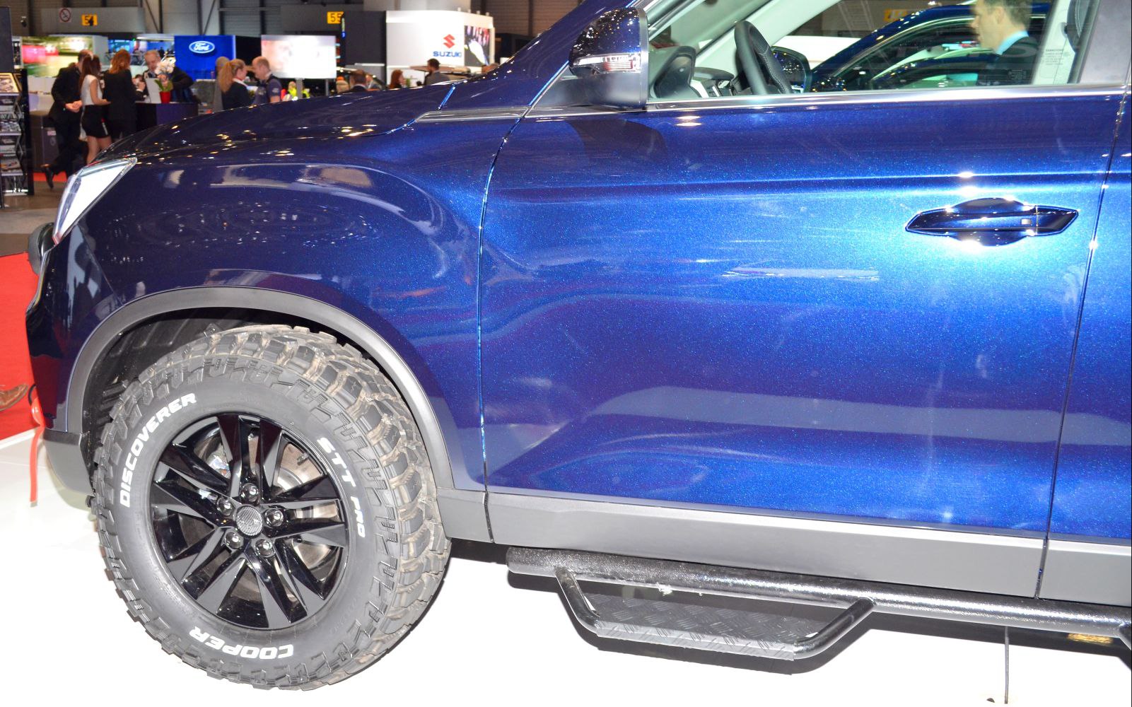Close-up of off-road tire and side step on a vehicle.