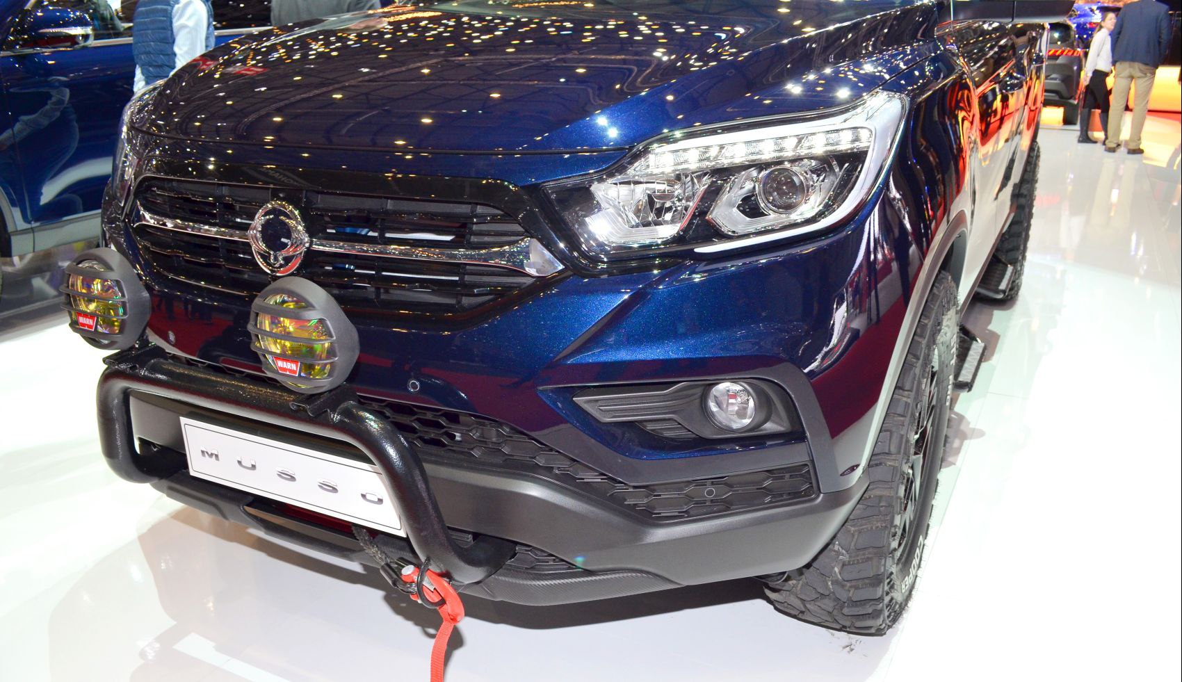 Bull bar and LED headlights on rugged truck front.
