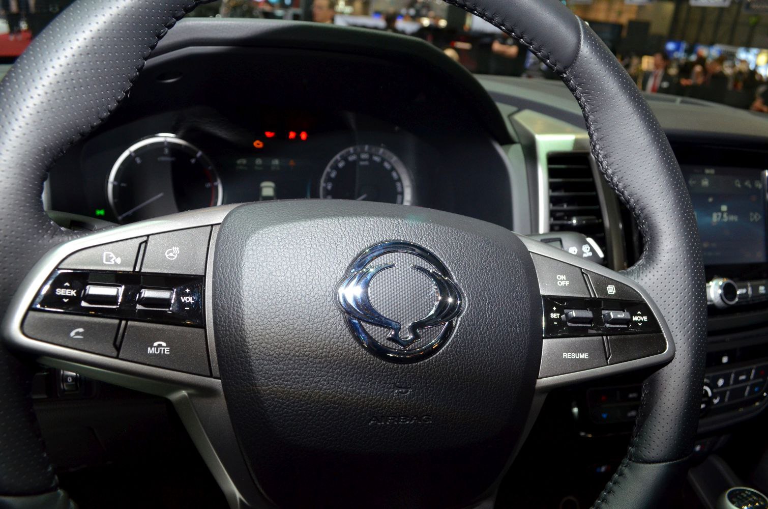 Steering wheel with multi-function controls and digital dashboard cluster.