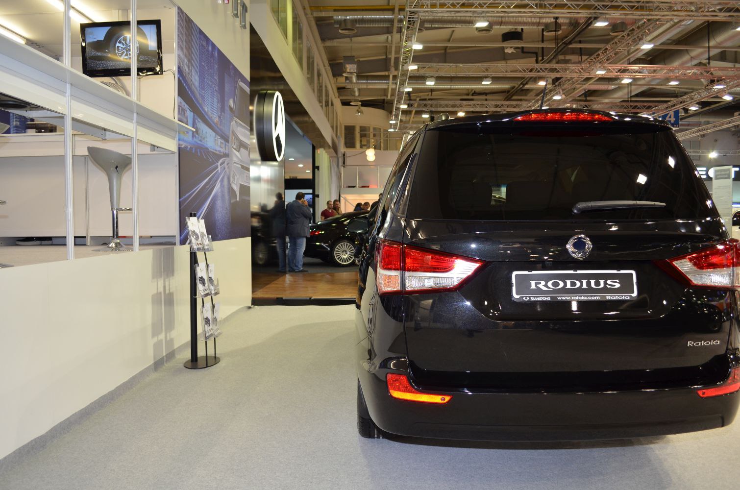 Rear view featuring modern tail lights and rear design of a black MPV.