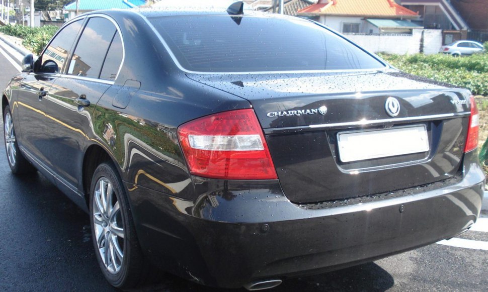 Black sedan rear with taillights and badges