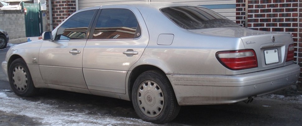 Silver sedan rear side with taillights and tinted windows