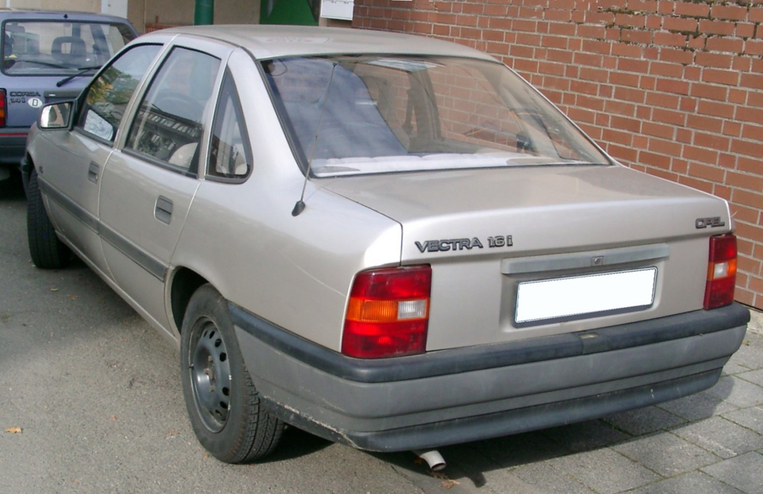 Rear view of a classic 1988 sedan with hatchback trunk and distinctive tail lights.