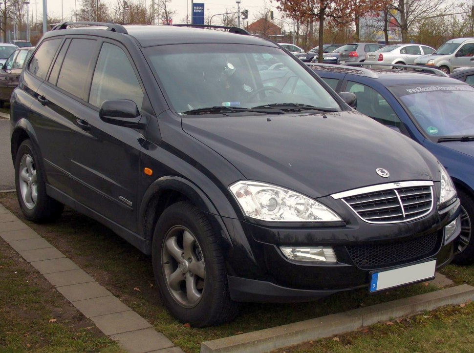 Front and side view of an SUV with chrome grille and dual headlights