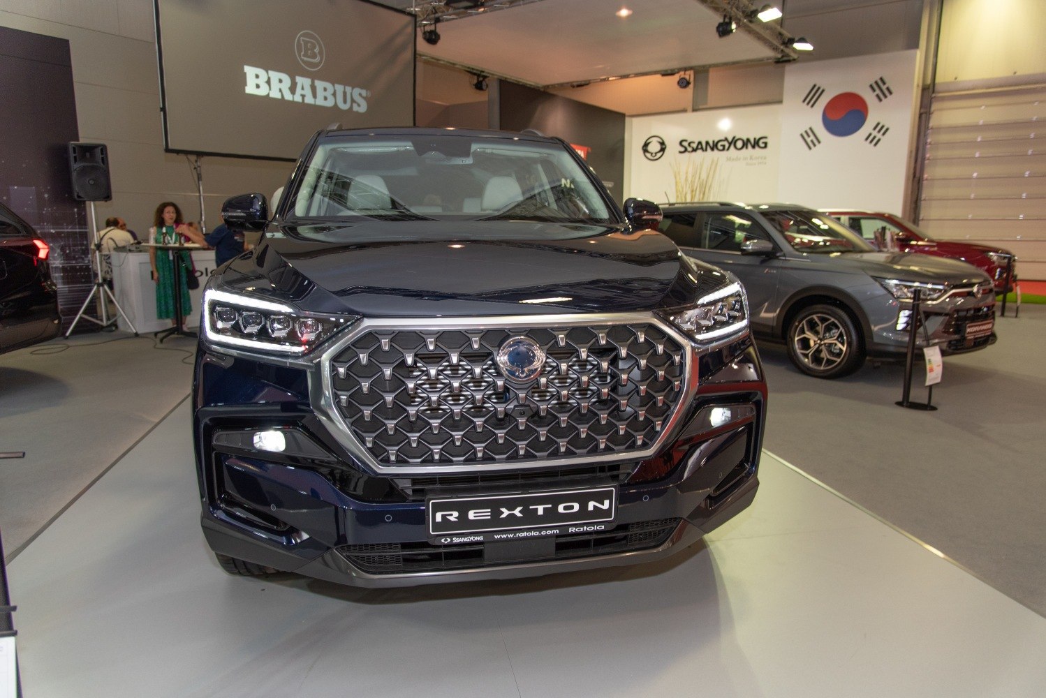 Front grille and LED headlights of a modern SUV at car exhibition