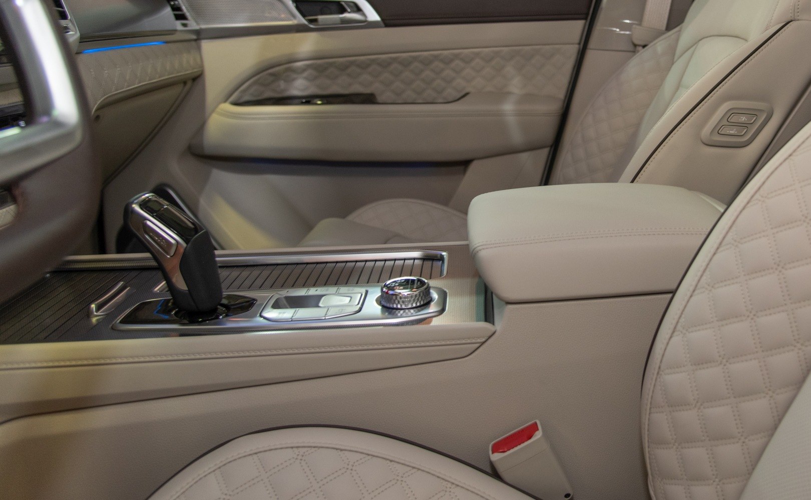 Quilted leather seats with gear shift and armrest in car interior