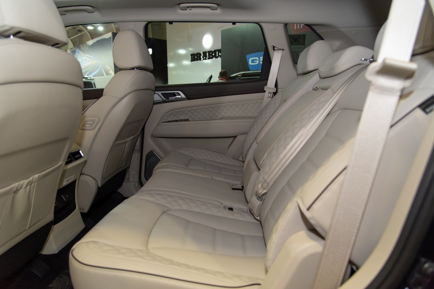 Beige leather rear seats with quilted stitching and spacious legroom