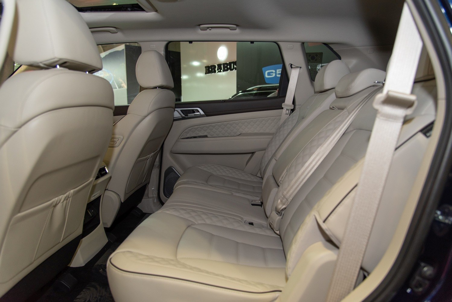 Beige leather rear seats with diamond stitching and spacious design