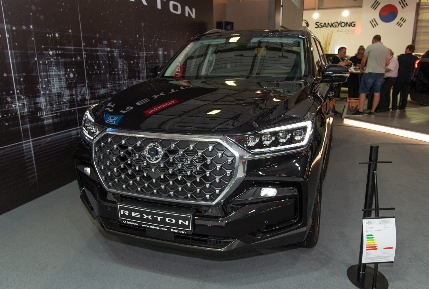 Hexagonal front grille with LED headlights on black SUV