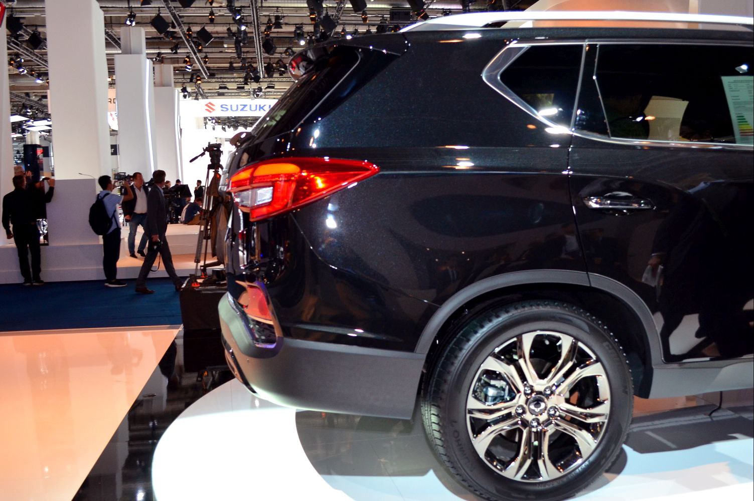 Rear side and alloy wheel of an SUV with distinct taillight and chrome trim.