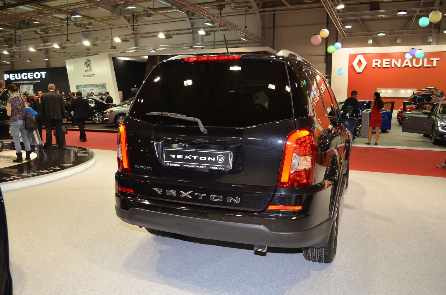 Rear view of black SUV with prominent vertical taillights and rear windshield wiper