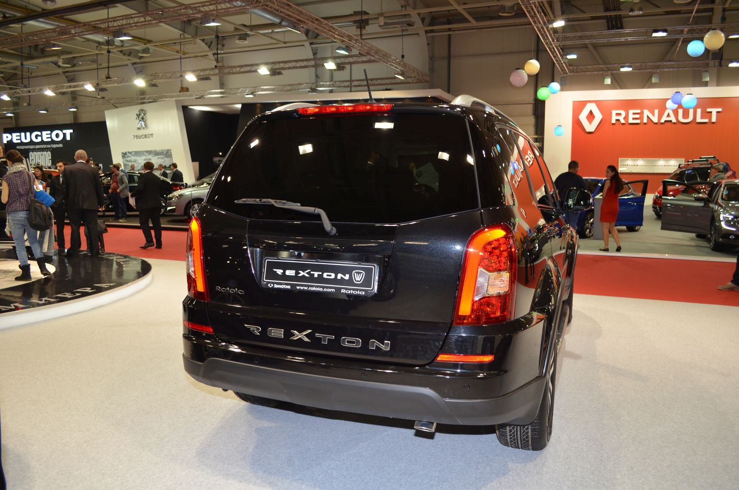 Rear view of a black SUV with illuminated taillights and rear wiper