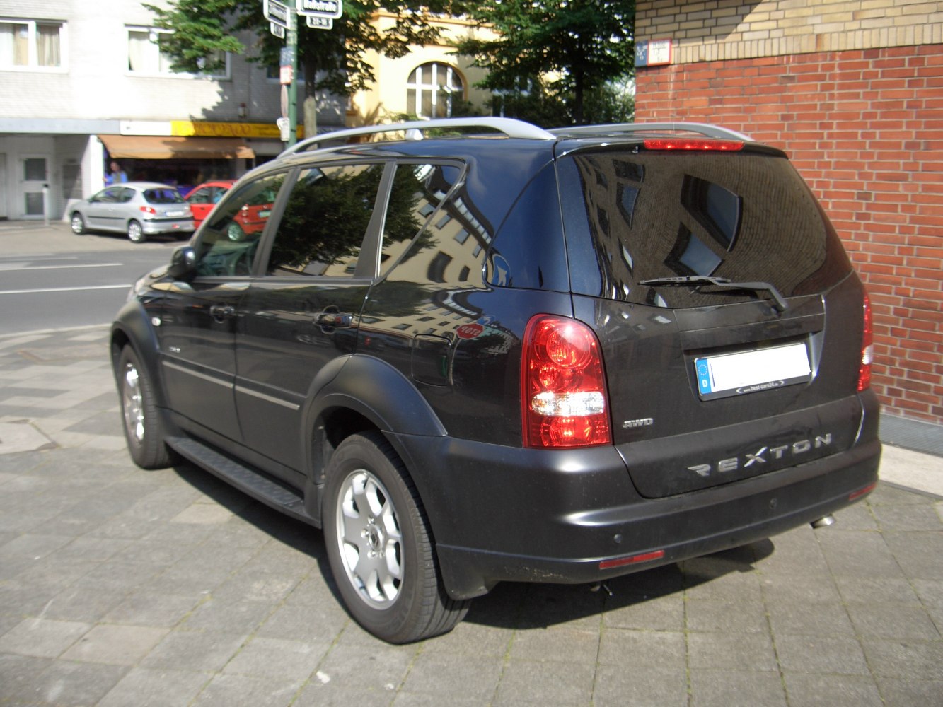 Rear and side view of SUV with roof rails and alloy wheels.