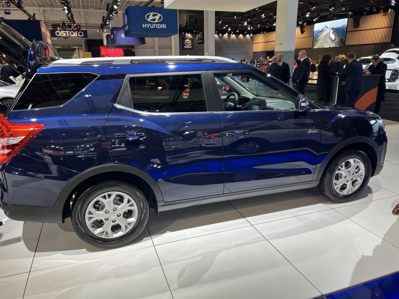 Sleek blue SUV side profile with alloy wheels and sharp character lines