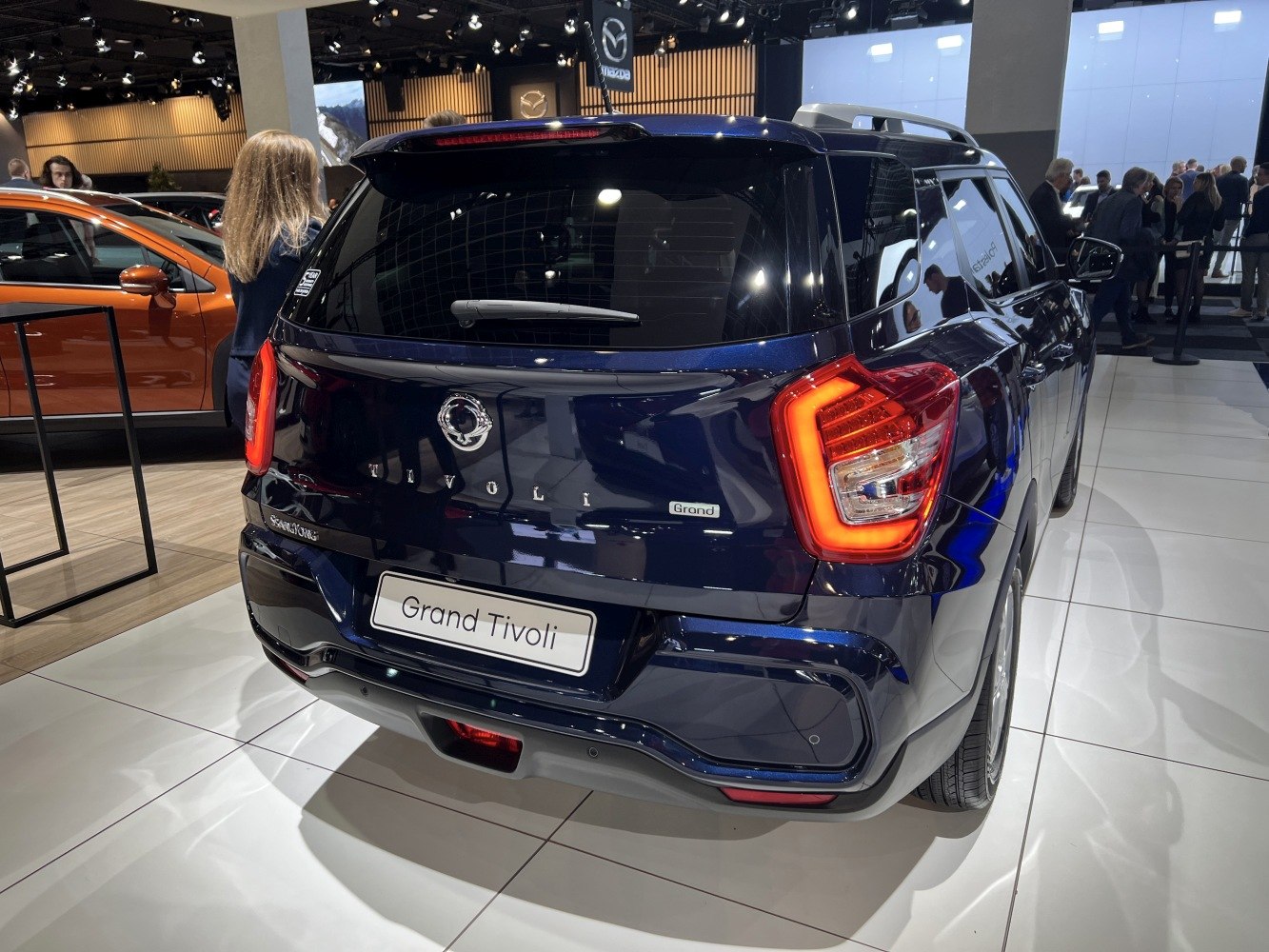 Compact SUV rear view with illuminated LED taillights and roof rails