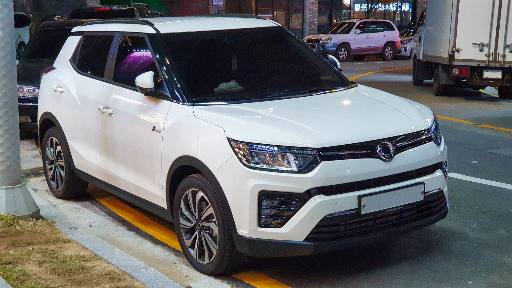White SUV front and side view with LED headlights and alloy wheels
