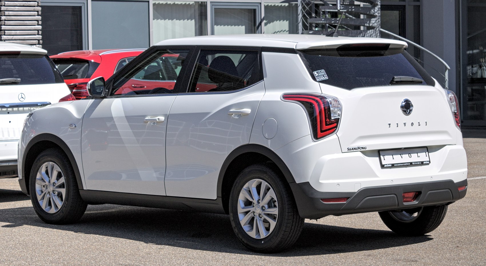Rear three-quarter view of white SUV with modern taillight design