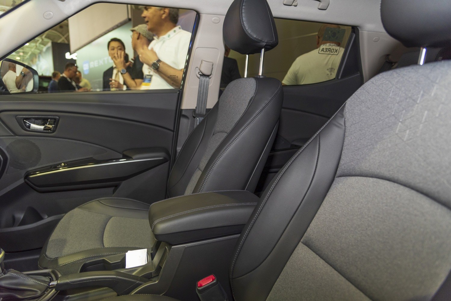Close-up of fabric and leather front seats with armrest and door panel