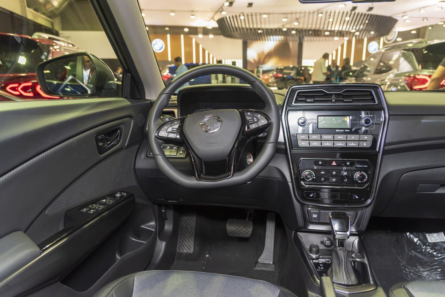 Dashboard, steering wheel with controls, and center console with infotainment and gear shift