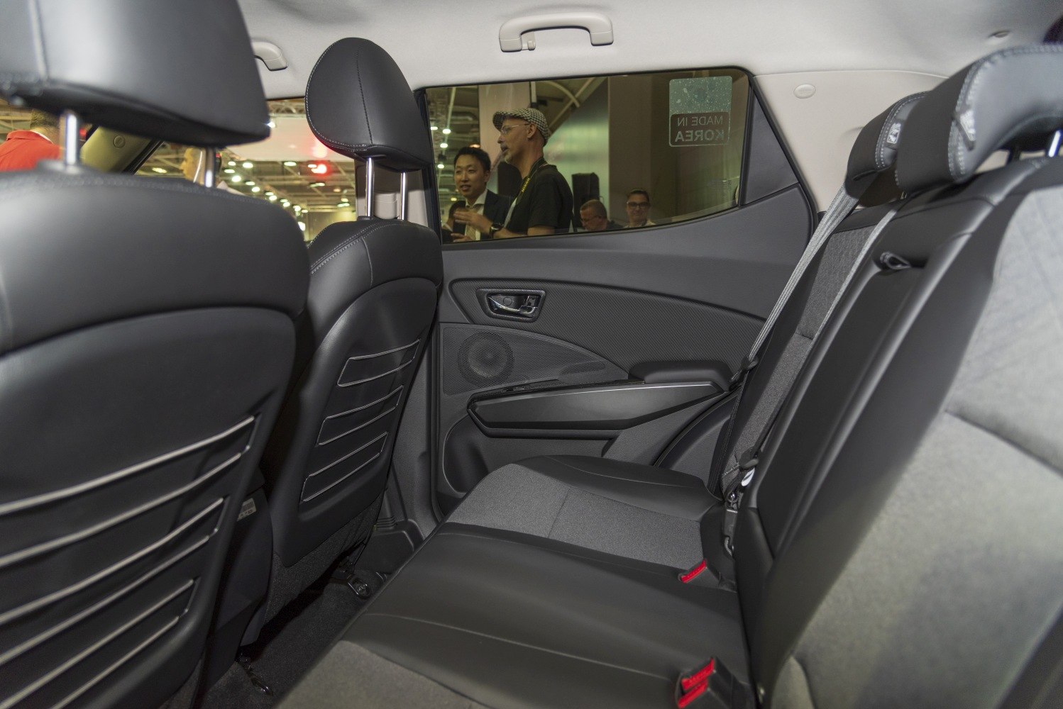 Rear seating area with black upholstery and door panel speaker
