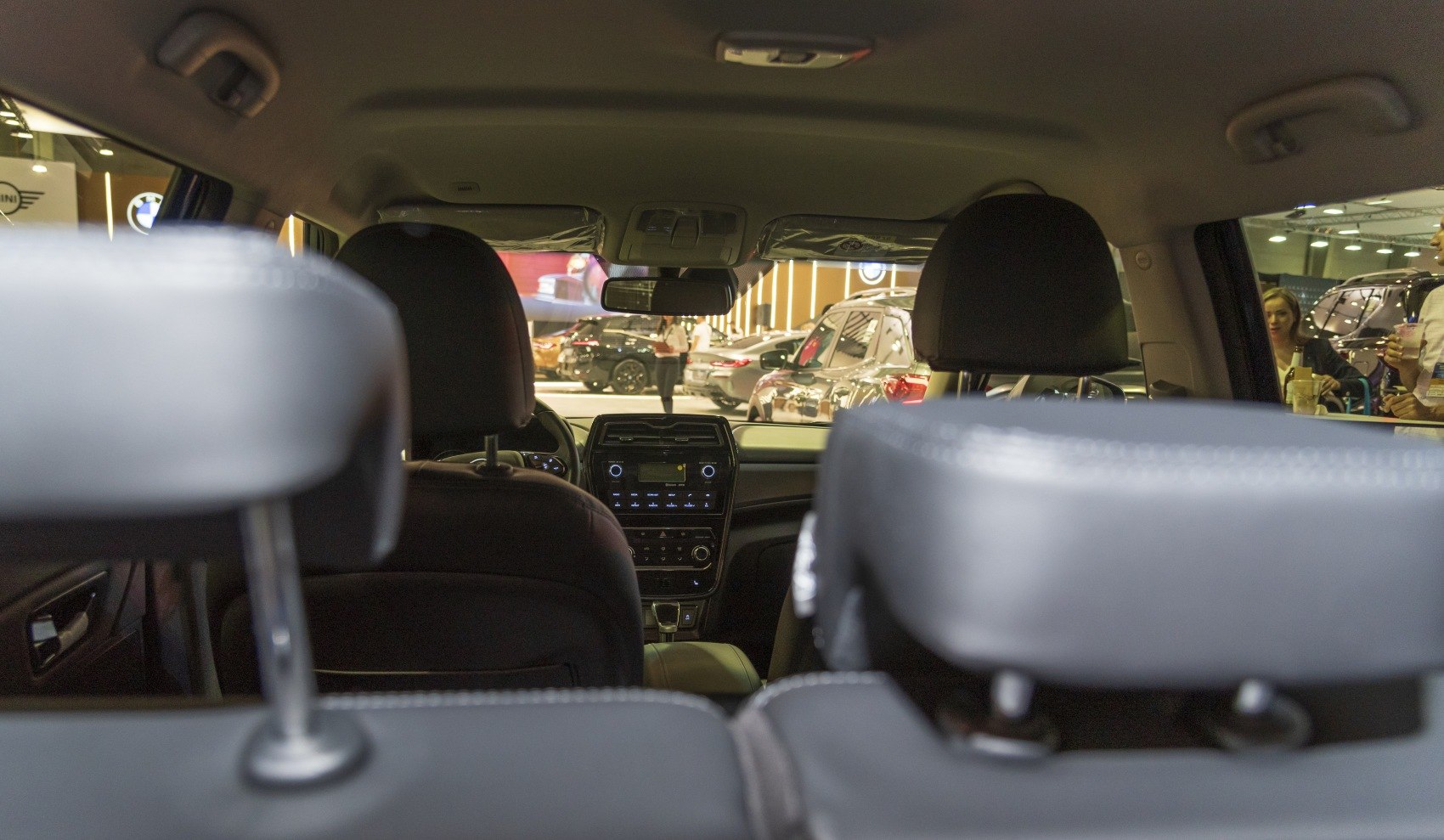 Front dashboard and seats interior view with control panel and headrests