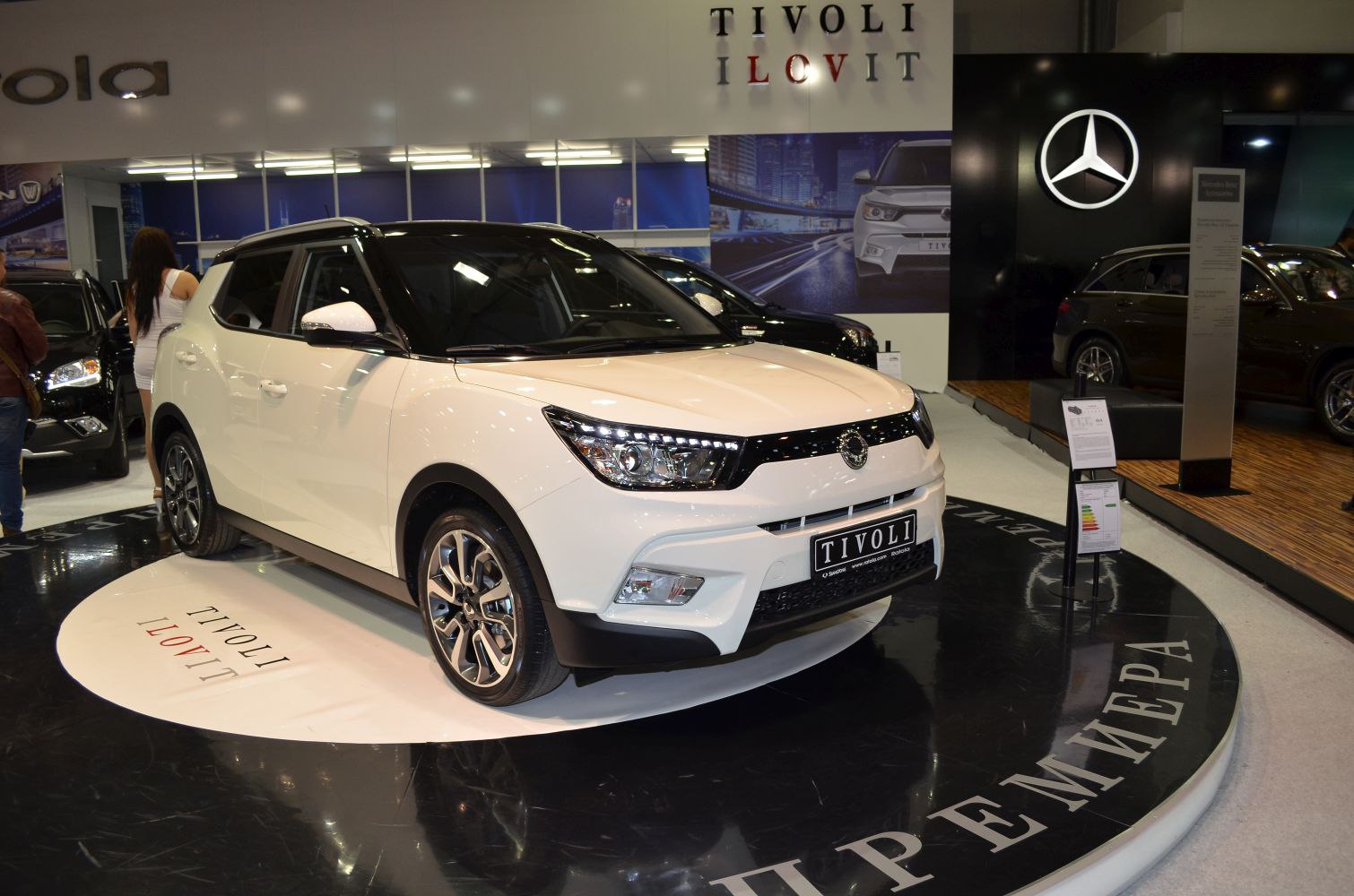 Front view with distinctive LED headlights and compact SUV body.