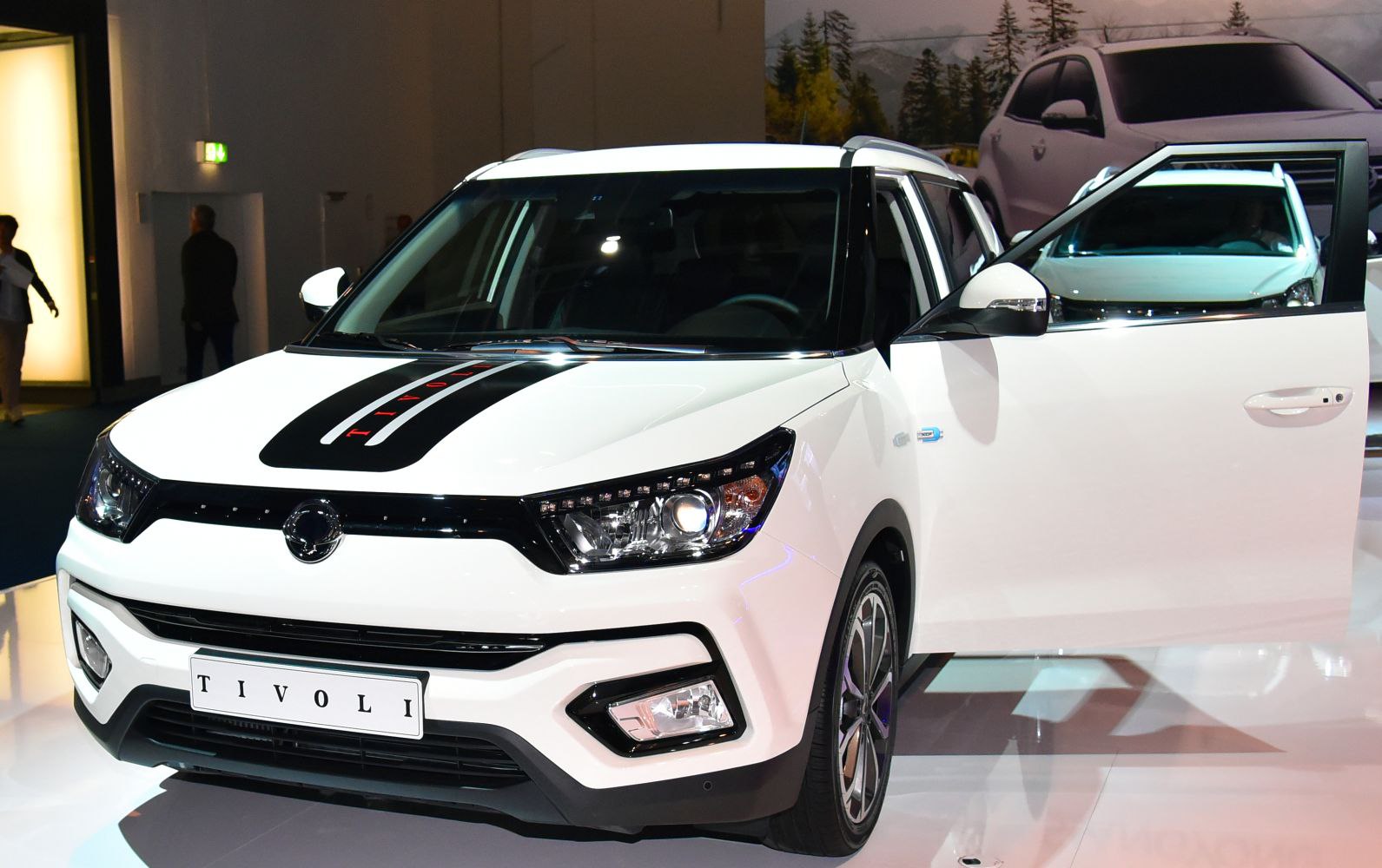 Front view of compact SUV with hood stripe and open front door