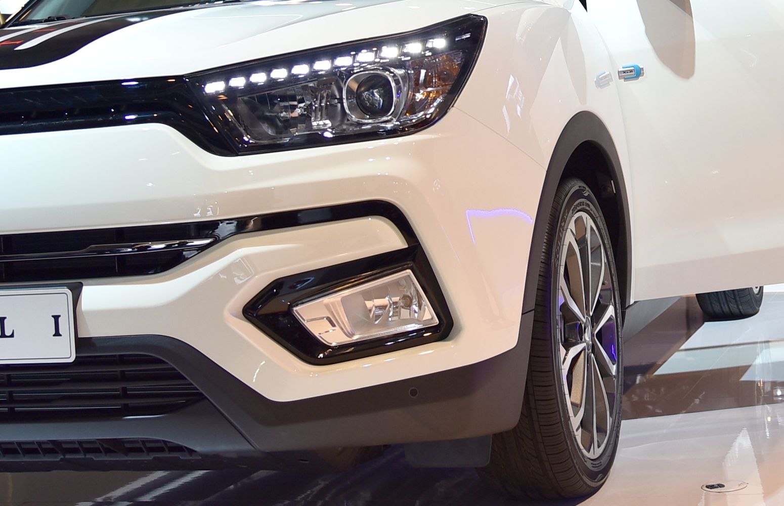 Front LED headlights, fog light housing, and alloy wheel close-up