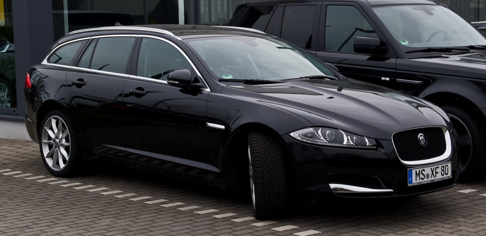 Sleek front and side profile of luxury estate with chrome trim and alloy wheels