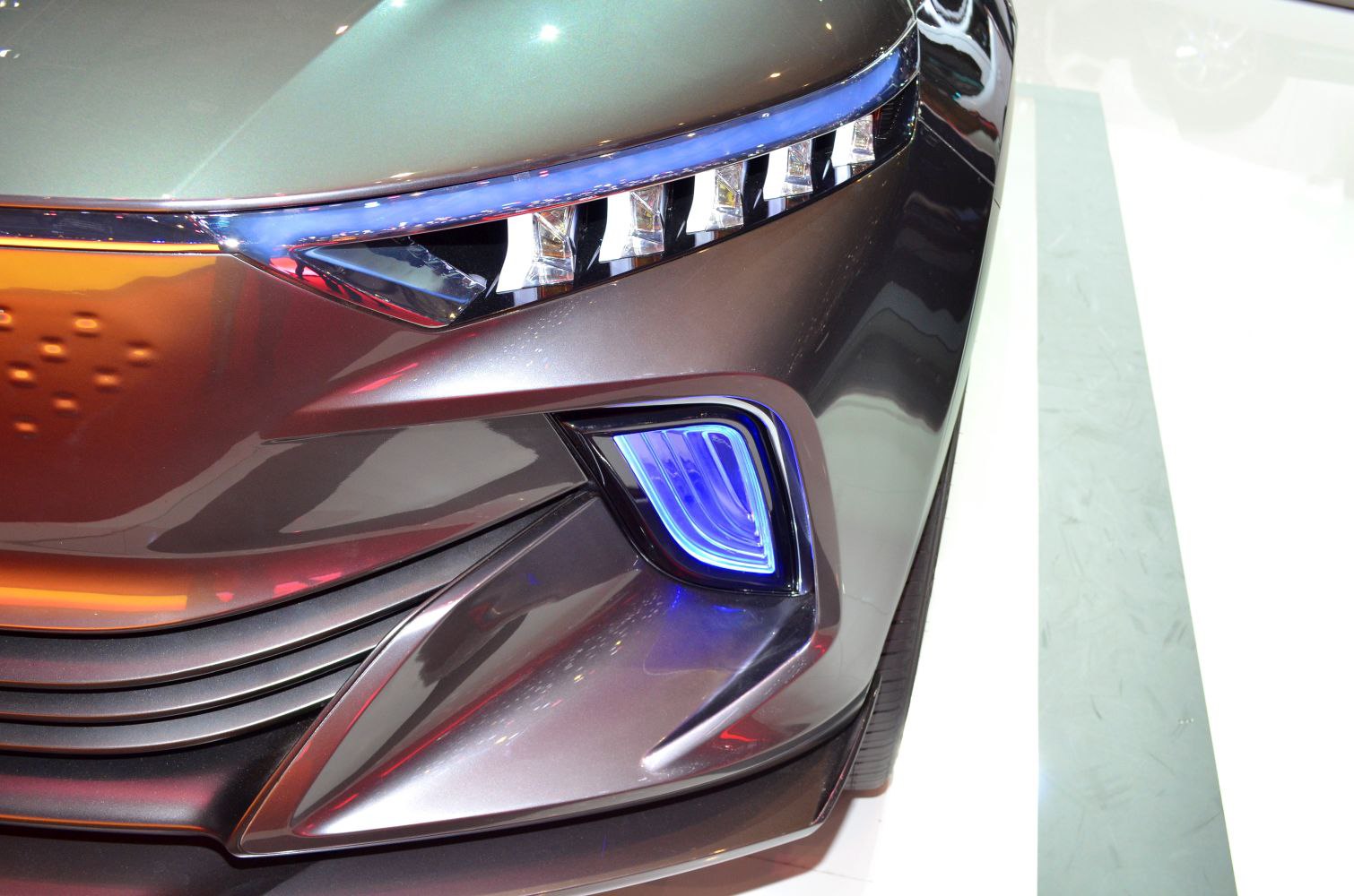 Close-up on front headlight and blue-accented fog light design