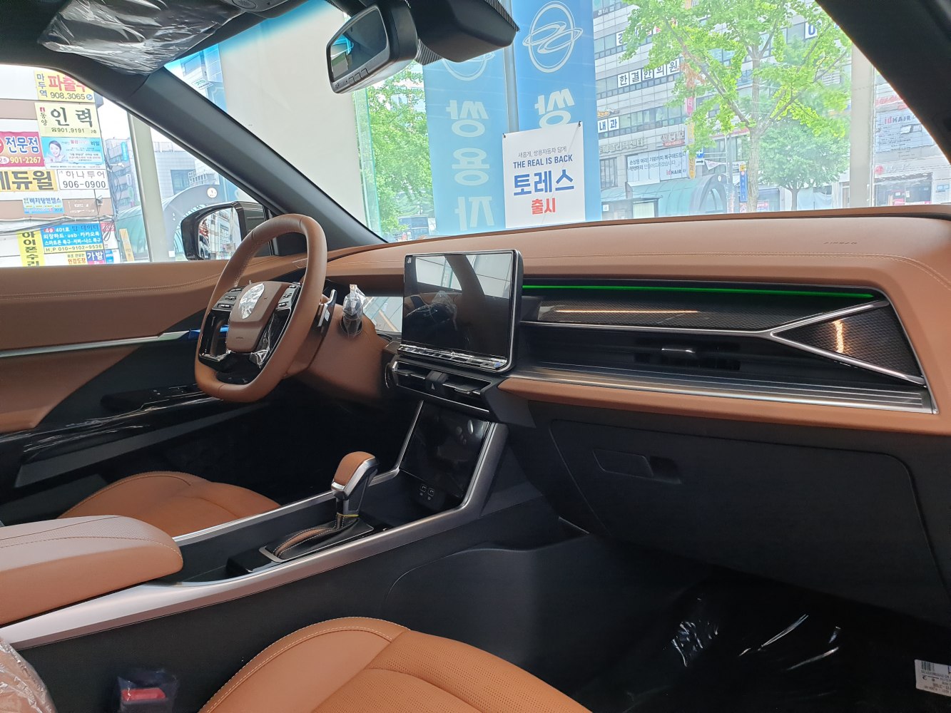 Digital touchscreen and brown leather interior with modern dashboard design