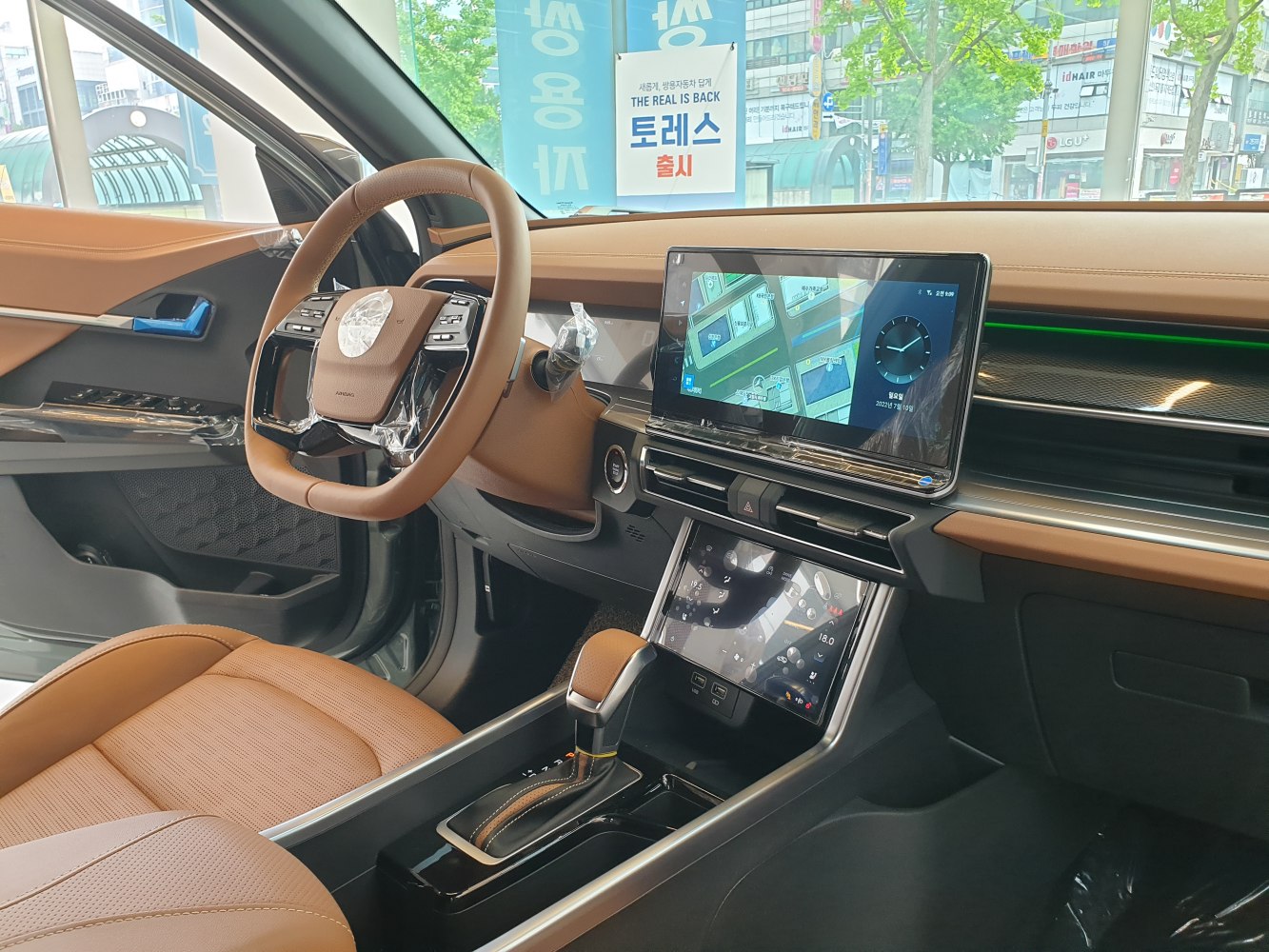 Dual touchscreen displays and brown leather interior