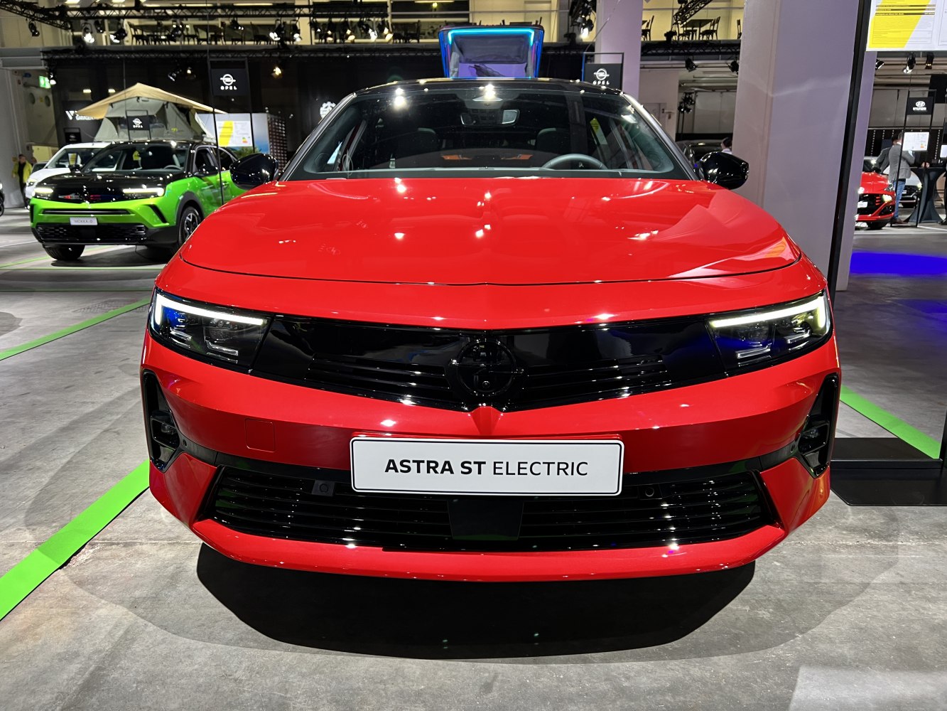 Red electric car front with black grille and modern headlights