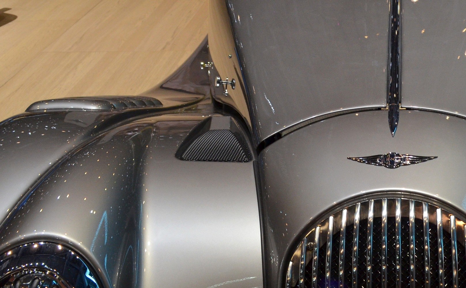 Close-up of front hood and chrome grille with unique vents