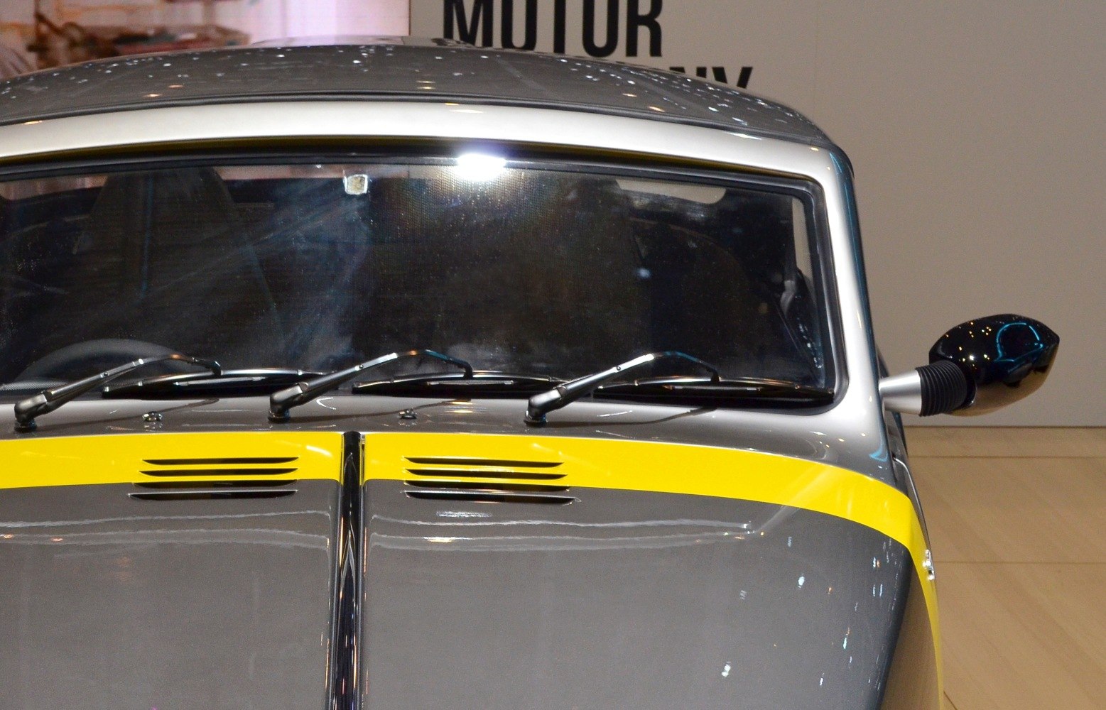 Hood with vents, windshield, windshield wipers, and side mirror view