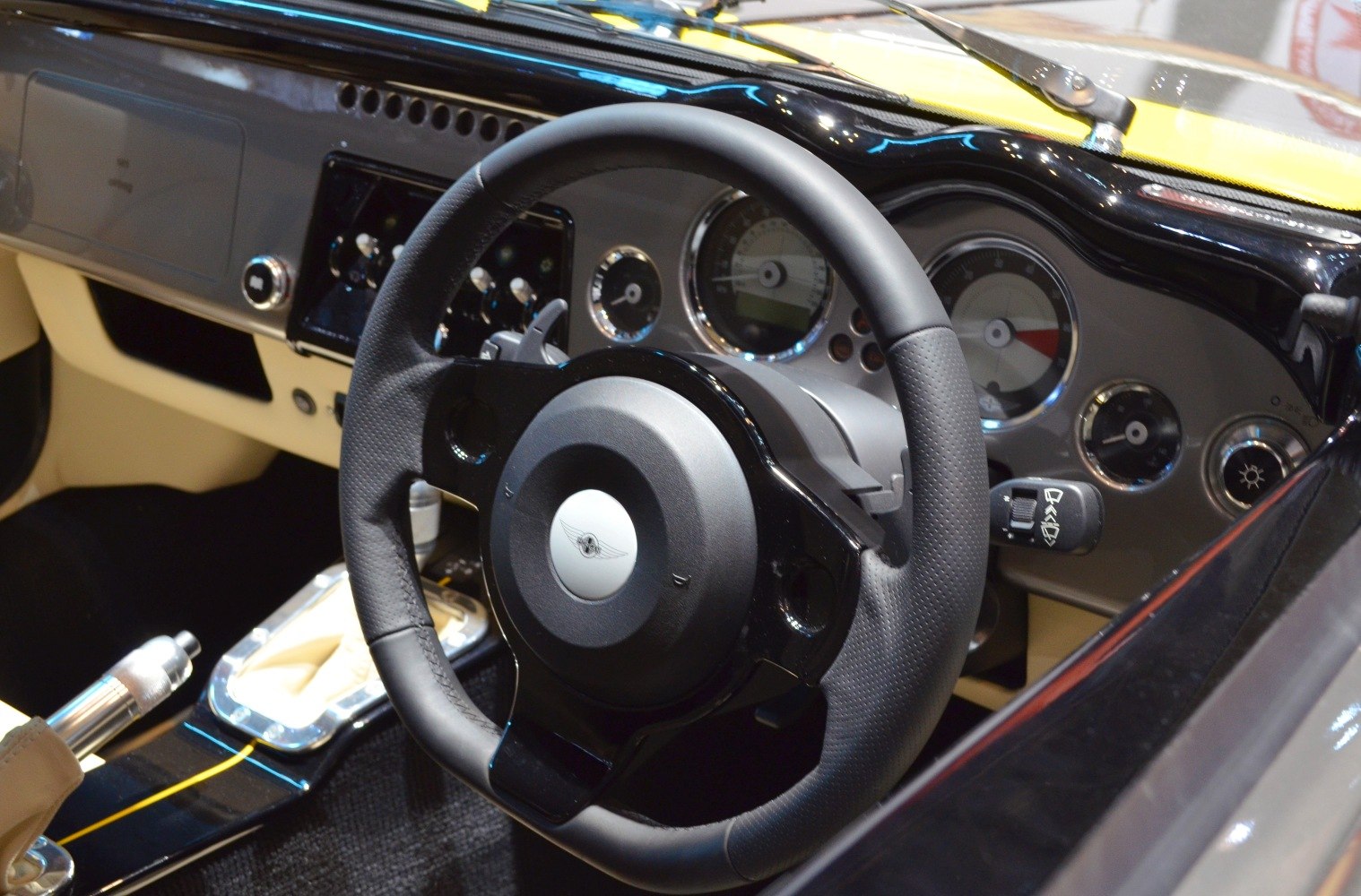 Close-up of classic car steering wheel and dashboard gauges