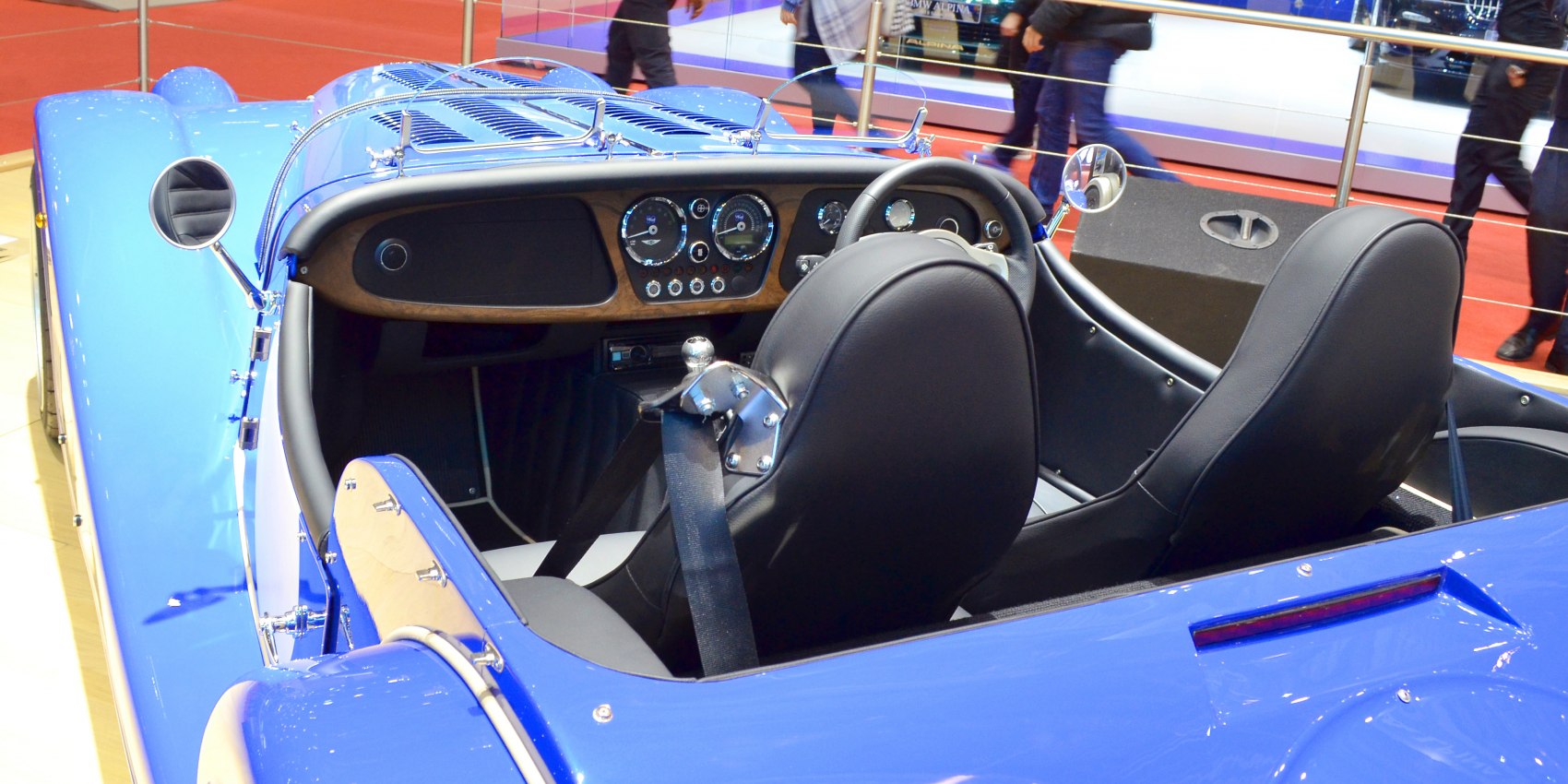 Vintage convertible interior with wooden dashboard and black leather seats