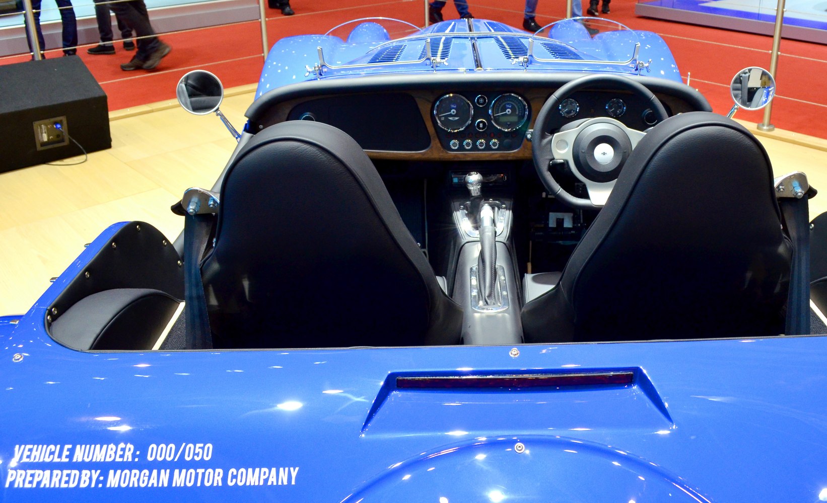 Wooden dashboard, round gauges, black convertible seats