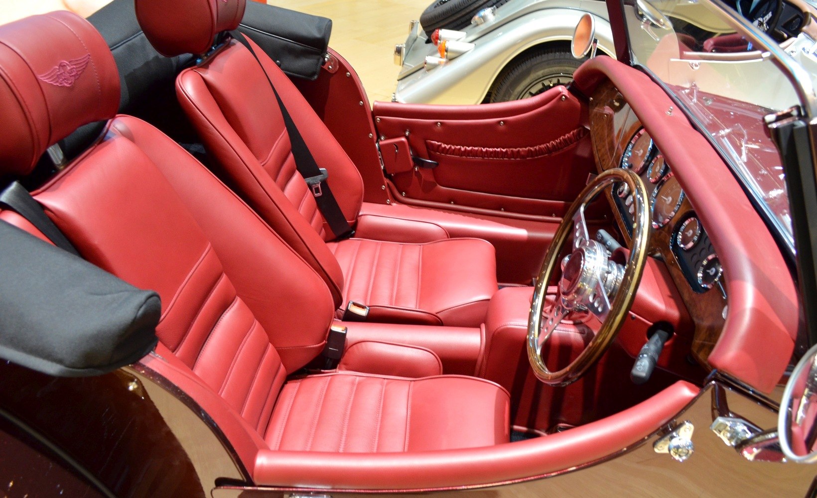 Red leather interior and wooden dashboard with vintage steering wheel