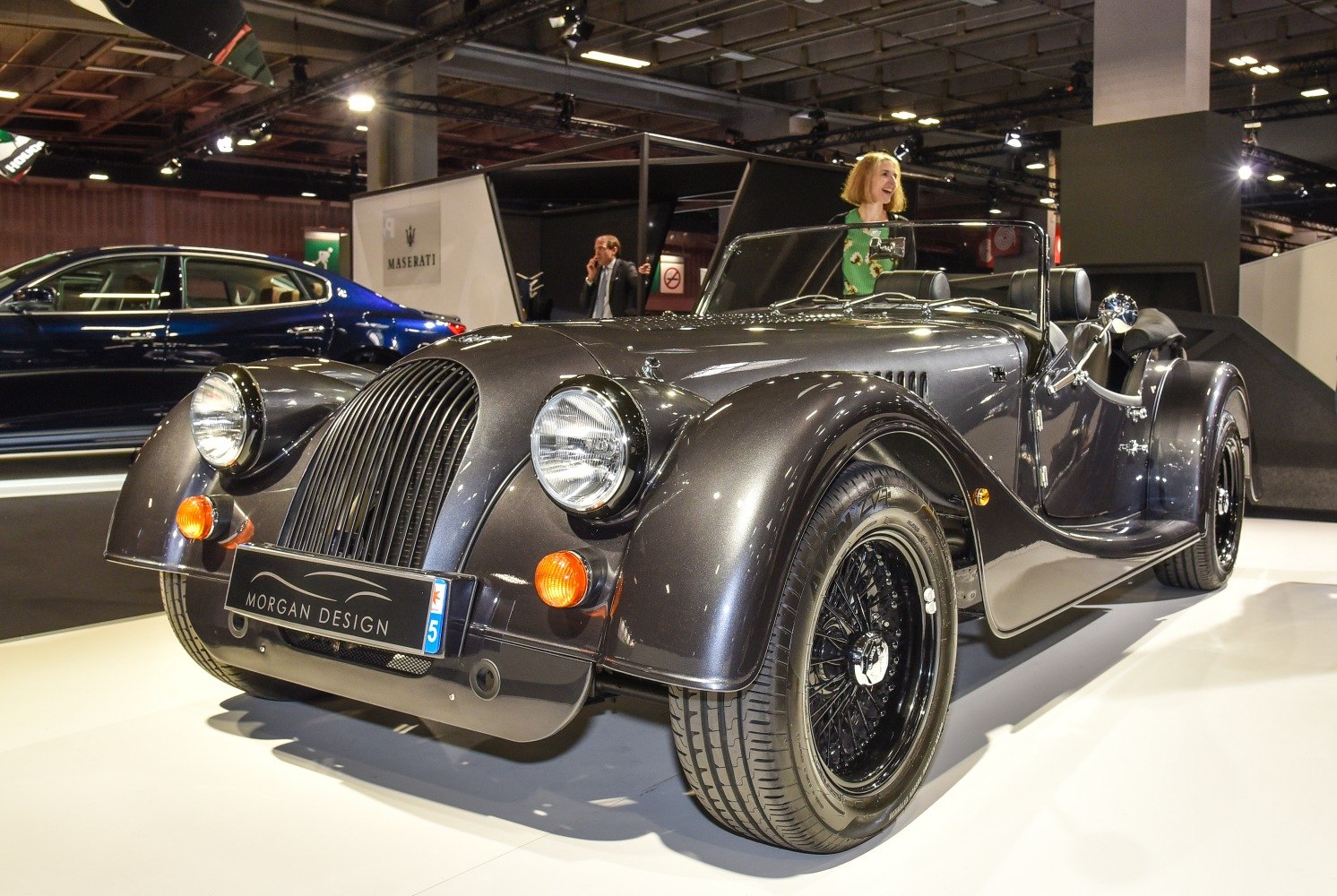 Vintage-style roadster with distinctive front grille and round headlights.