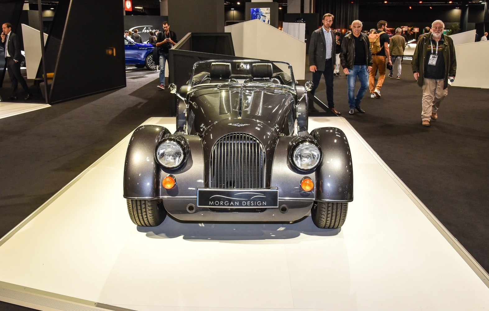 Classic roadster front with vintage vertical grille and round headlights